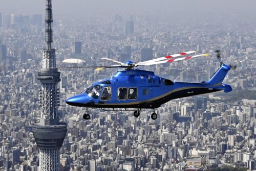  東京都内上空を飛行する、読売新聞東京本社と日本テレビ放送網が共同運航を始めた新型ヘリコプター。左は東京スカイツリー（４月１日撮影）