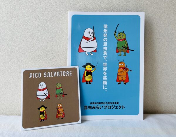  「PICO SALVATORE」のパンフレットの表紙は、蚕（シルク）や蜂の子（ハチノコ）などをモチーフにしたブランドキャラクターの「小さな救世主」